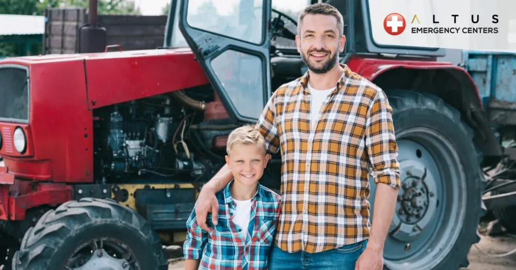 Father and son in front of a tractor