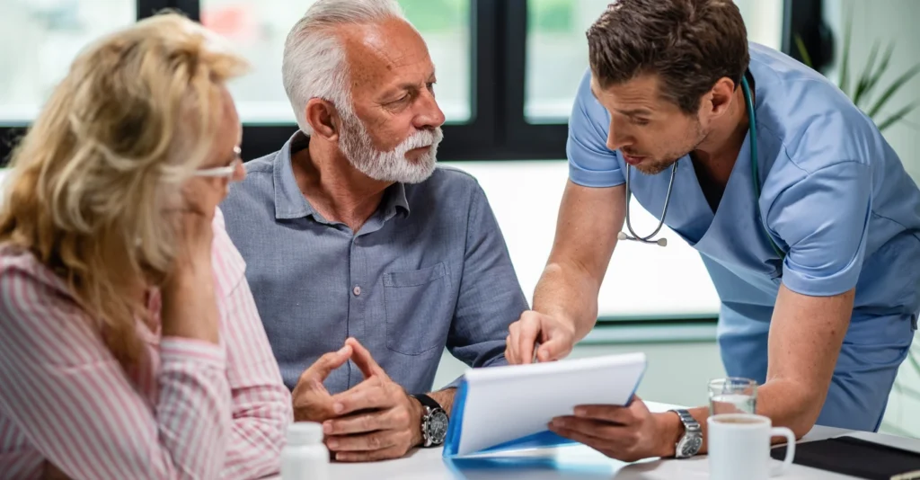 serious_doctor_discussing_with_senior_couple_about_their_medical_documents_appointment_clinic