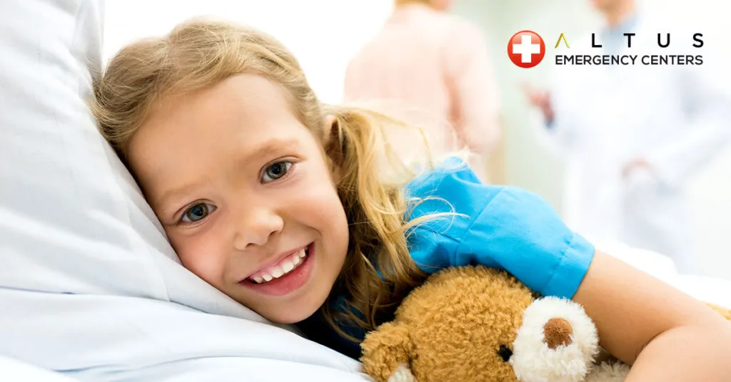 child hugging a teddy bear