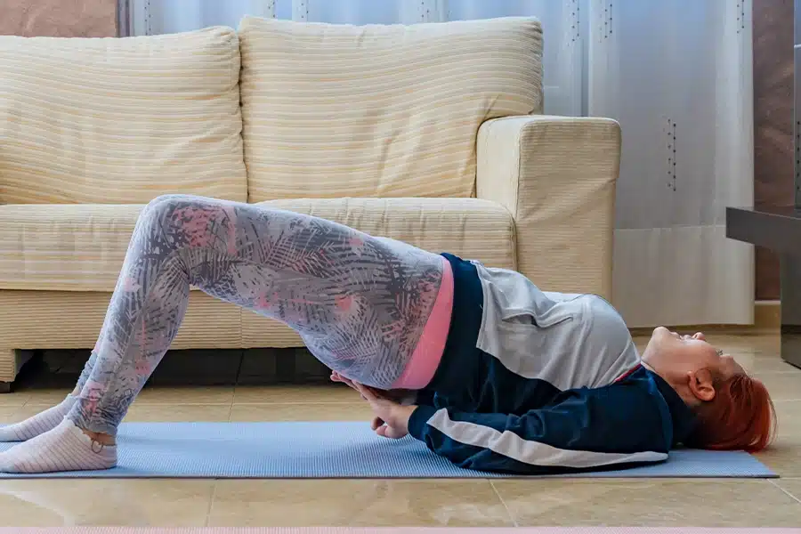 Woman performing bridge exercise for hip pain relief.