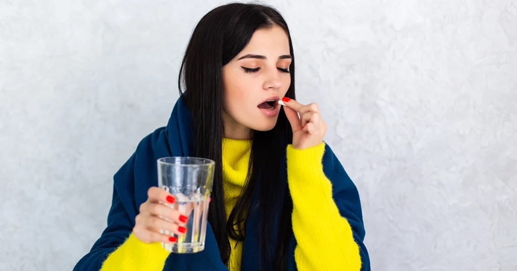 Woman taking antibiotics that may cause diarrhea symptoms