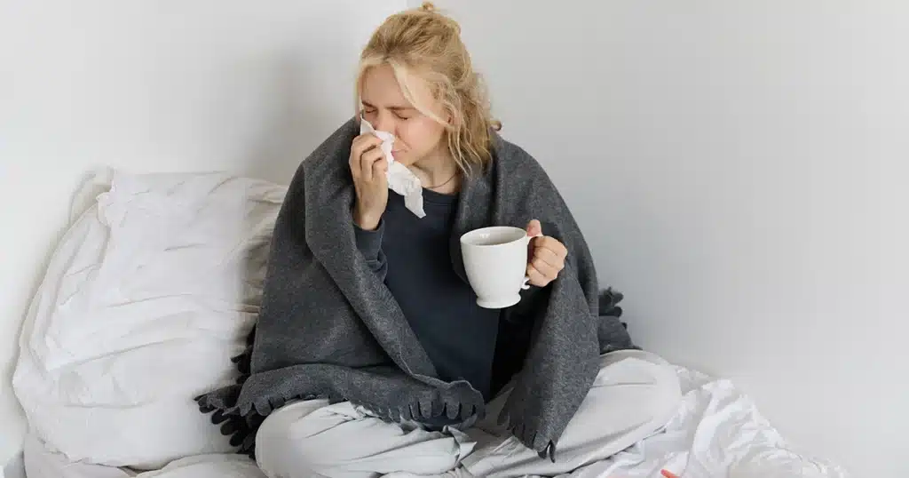 Person experiencing flu symptoms including congestion and fatigue.