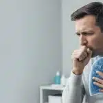 Man coughing with symptoms of bronchitis and pneumonia