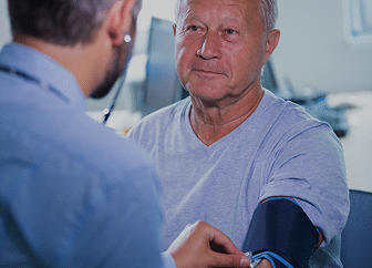 A healthcare professional checking a senior patient's blood pressure