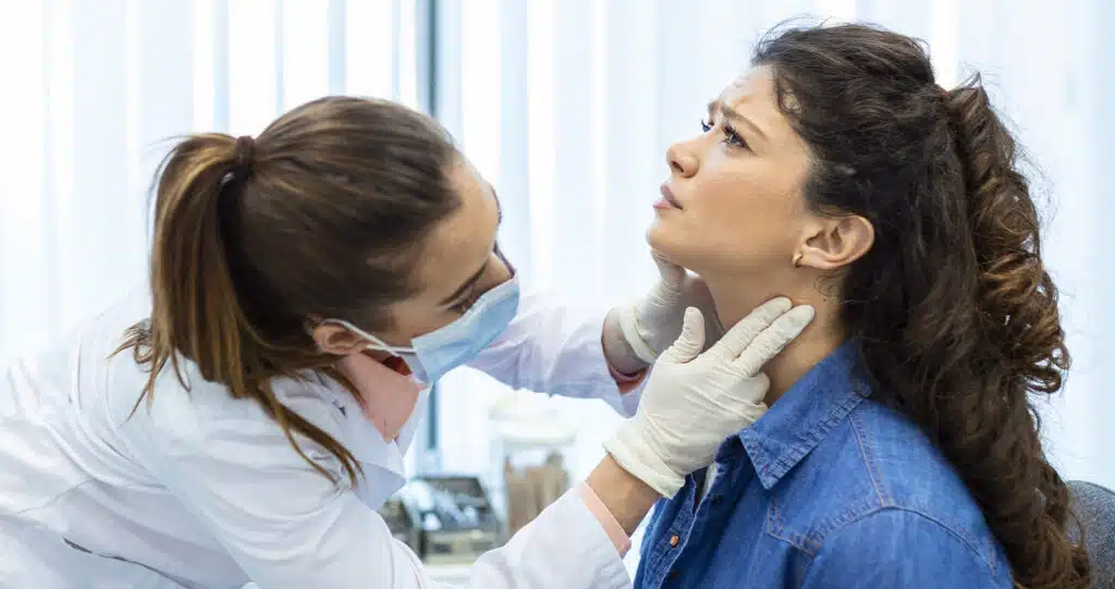 Doctor examining a patient's throat.