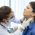 Doctor examining a patient's throat.