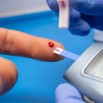 Close-up of a person getting their blood glucose tested.