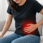 Woman holding her lower left abdomen in pain.