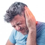 A man with a pained expression holding his ear, which is highlighted with a red glow to indicate discomfort or pain.