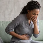 Woman experiencing nausea and stomach cramps